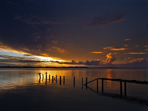 light sunset colour water clouds reflections jetty surreal pelican qld posts