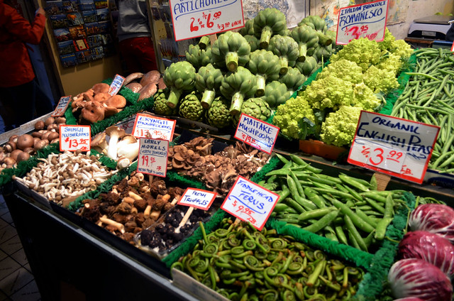 A vegetable stall selling different types of vegetables and mushrooms.