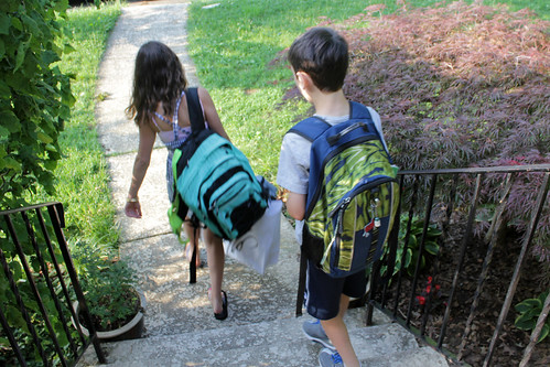 the kids, with their heavy backpacks, head out to the bus
