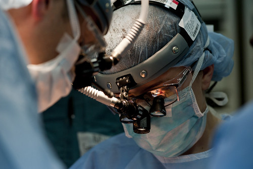 A Navy officer performs surgery on an Indonesian patient in an operating room aboard USNS Mercy.