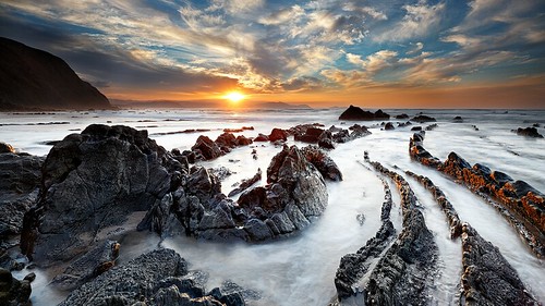 sunset seascape beach spain rocks tail lizard sapin barrika cresende northphototours jurassicbay biscaycolor