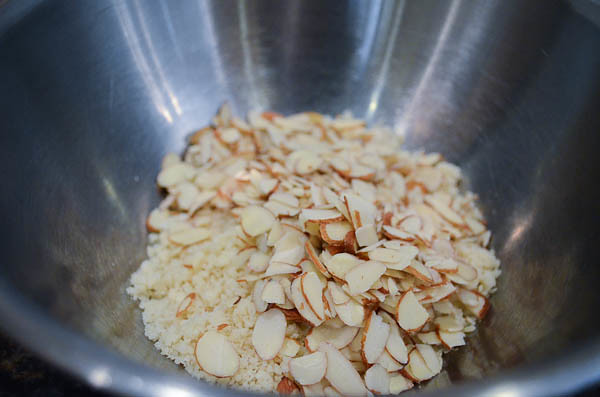 Sliced almonds and the crumb mixture are combined in a large bowl.