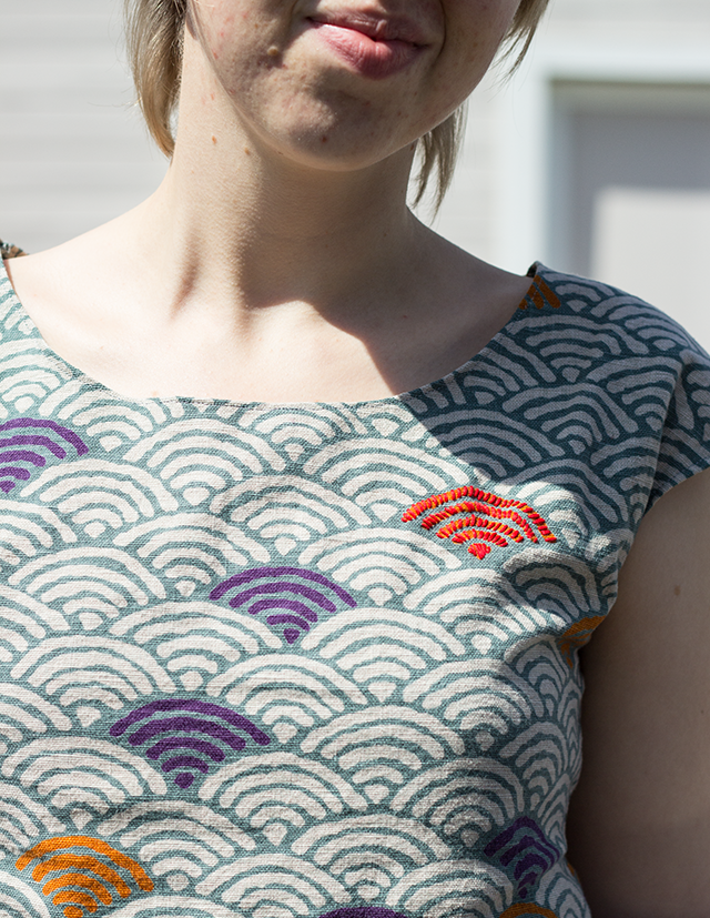 red embroidered embellishment on Japanese wave-pattern fabric top