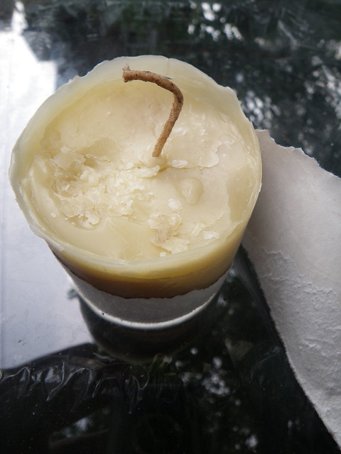 ripping away beewax candle mold