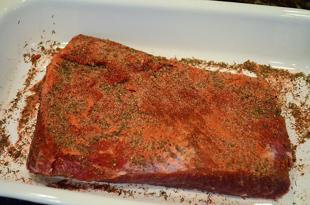 The beef brisket flipped upside down so spice rub can be added.