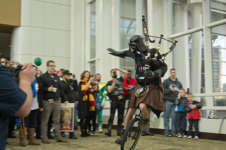 Darth Vader in a Kilt playing the Bagpipes on a Unicycle