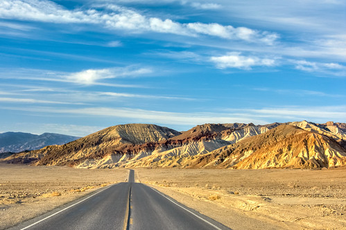 deathvalley california unitedstates usa drive road tarmac national park badwater low point desert sand yellow mountain mountains sky skies clouds blue desertroad symmetrical vanishingpoint landscape sunset hue travelpf