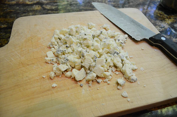 Gorgonzola that has been chopped up with a knife into crumbly small pieces.