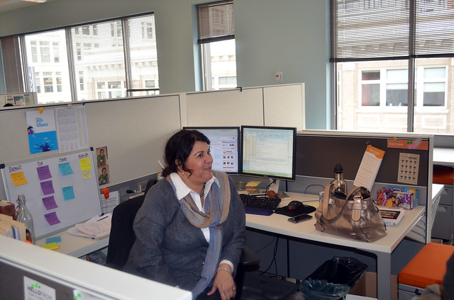 Cory Vicens sitting at her office desk.