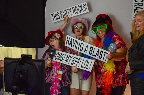 A group of ladies dressed up in costumes holding signs posing for a photo.