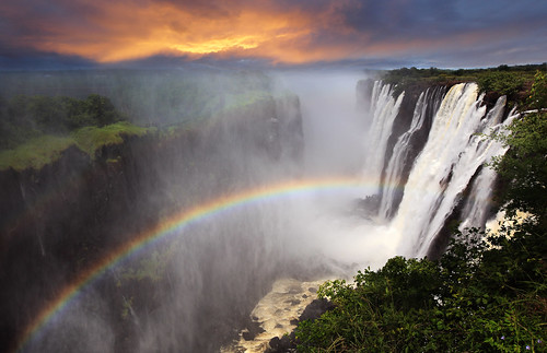 africa morning travel sunset vacation orange holiday tourism nature water clouds river spectacular landscape waterfall rainbow warm postcard atmosphere falls spray foam victoriafalls dramaticsky idyllic atmospheric pleasant zambia morningsky zambezi enjoyable scenicview zambeziriver dramaticlandscape