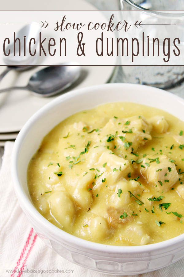 Slow Cooker Chicken and Dumplings in a white bowl with a spoon.