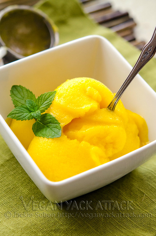 Mango lime sorbet in a white bowl with a spoon