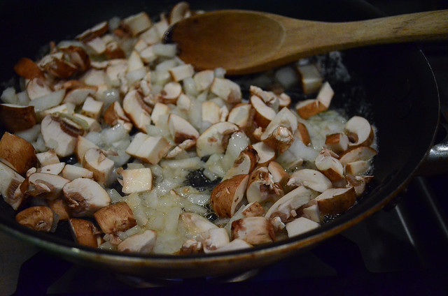 Mushrooms and onion cooking in a pan.