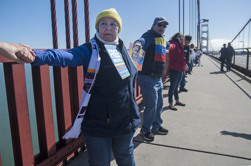 Thamar Ramirez, a Venezuelan citizen who arrived in San Francisco just two weeks ago, links hands with other protesters to form a human chain across the Golden Gate Bridge during a demonstration in support of the Venezuelan people Sunday, Feb. 23. Photo by Jessica Christian / Xpress