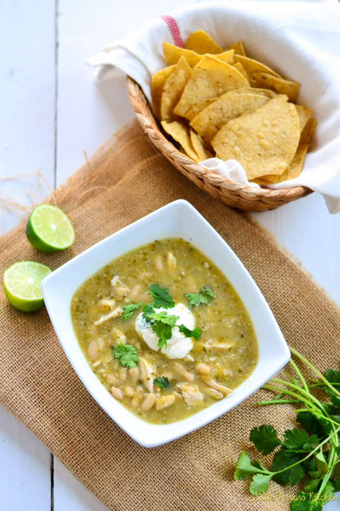 Chile verde recipe is topped with sour cream, fresh cilantro and extra lime juice. Serve with tortilla chips.