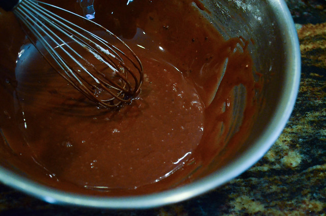 The cake's glaze being whisked in a bowl.