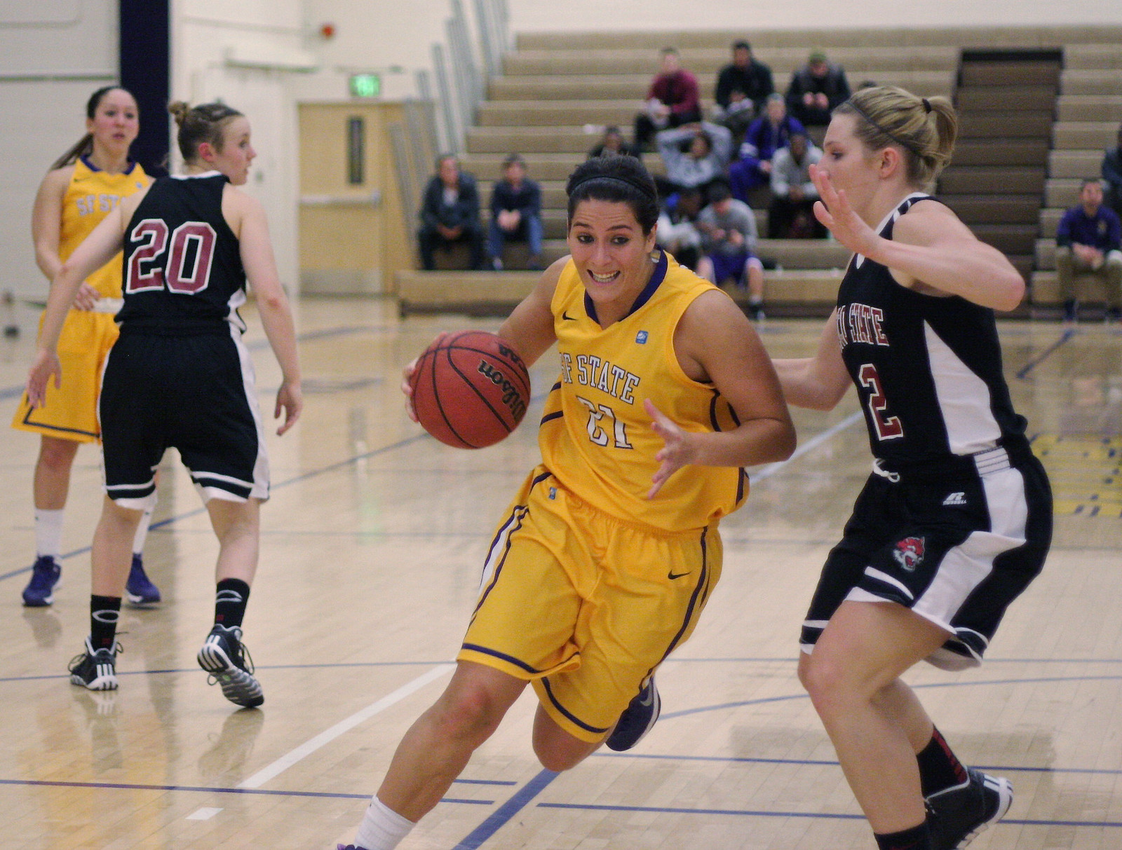 Katie Batlin (#21) dodges the other team at the SF State vs. Chico State Women's Basketball game at the Swamp on Friday, Dec. 6, 2013. Photo by Ryan Leibrich / Xpress