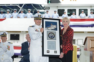 Collette Eddy, daughter of William Trump, presents Lt. Jared Harlow a plaque during the commissioning ceremony for the Coast Guard Cutter William Trump at Coast Guard Sector Key West, Fla., Jan. 24, 2015. Coast Guard hero, Petty Officer 1st Class William Trump, was awarded the Silver Star for valor in action during the assault phase of the landing at Normandy during World War II, more than 70 years ago. (U.S. Coast Guard photo by Petty Officer 3rd Class Jon-Paul Rios)