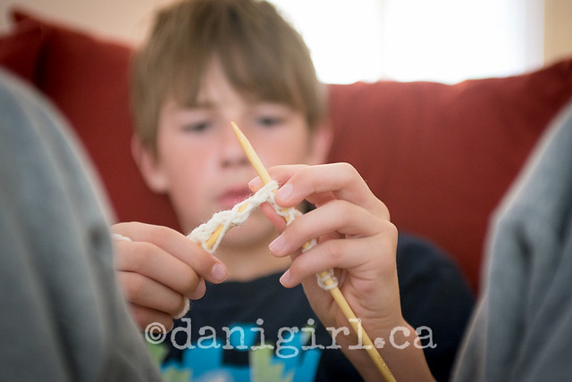 picture of a boy learning to knit