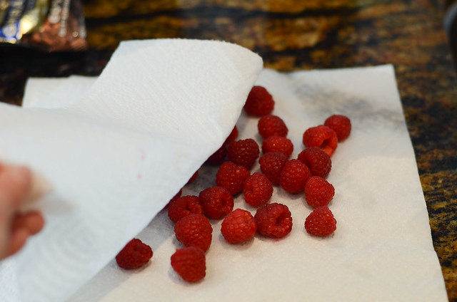 Raspberries draining on paper towels.