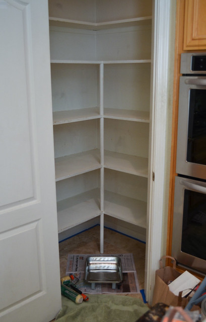A close up an empty pantry with the door open.