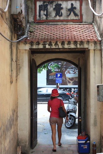 walking out of a corridor in the streets of Hanoi