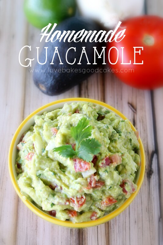 Homemade Guacamole in a bowl with fresh vegetables.