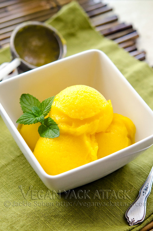 White bowl with mango lime sorbet inside and a mint garnish