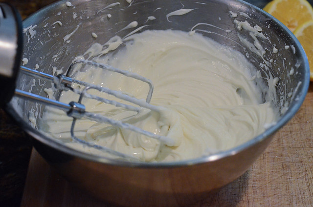 The ingredients for the cheesecake filling are being mixed together in a bowl.