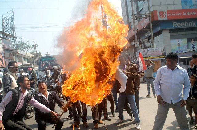 AGP burns effigy of Prime Minister Narendra Modi condemning the tag of 'immigrant' on North-eastern people on BJP's vision document, in Guwahati on Wednesday.