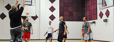 Staff and students playing basketball