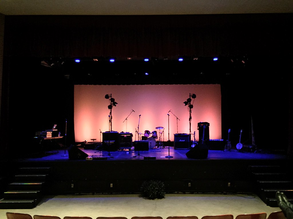 Band setup with moody blue and orange lighting at Edson Auditorium