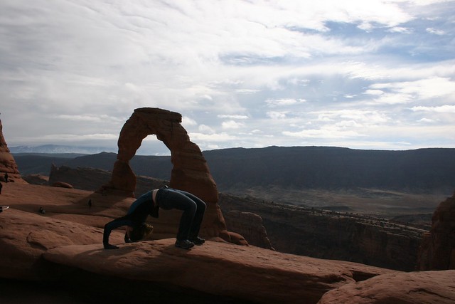 Sondy Alessondra Springmann mimicking Delicate Arch at Arches National Park