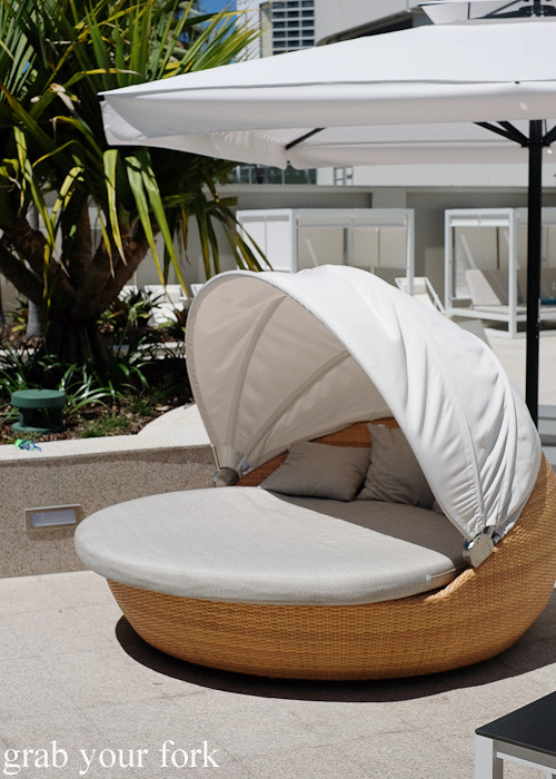 Lounge pods by the outdoor swimming pool at Jupiters Gold Coast