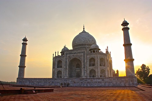 The sun rises behind the Taj Mahal