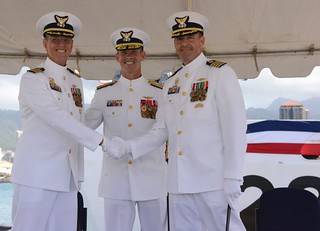 Capt. Kevin A. Jones shakes hands with Capt. Aldante Vinciguerra during a change of command ceremony for Coast Guard Cutter Sherman at Base Honolulu Feb. 4, 2015. Vice Adm. Charles W. Ray, commander, Pacific Area, presided over the ceremony which represents the transfer of total responsibility, authority and accountability to Vinciguerra. (U.S. Coast Guard photo by Petty Officer 3rd Class Melissa E. McKenzie)
