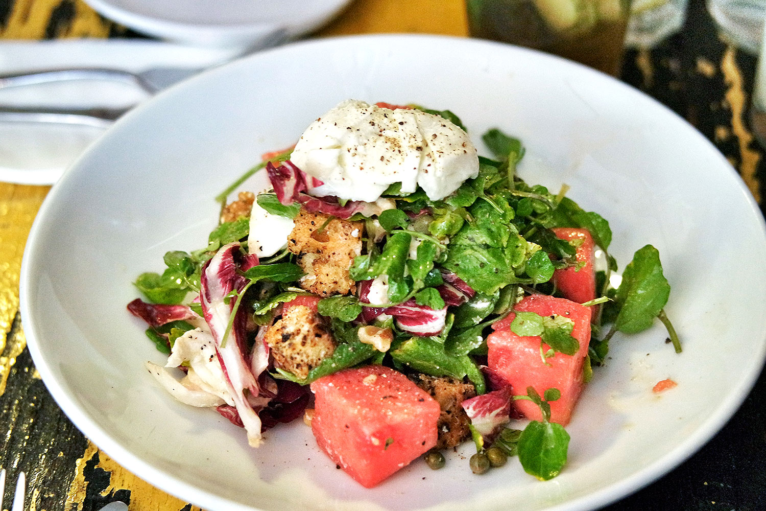 rose-infused watermelon salad with watercress, mozzarella and capers.