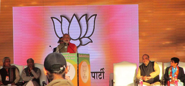 Prime Minister Narendra Modi addresses a rally at Karkardooma on Saturday ahead of the February 7 assembly elections in Delhi. Also seen on stage is BJP president Amit Shah and party's CM candidate Kiran Bedi.