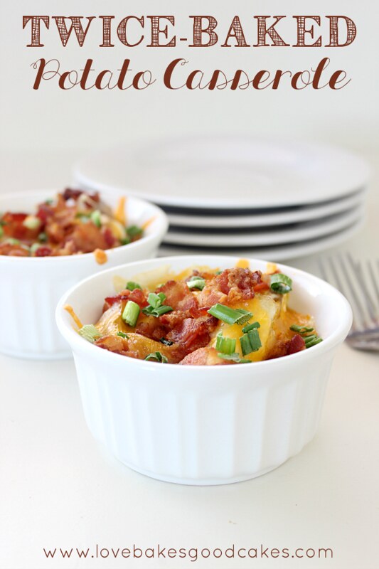 Twice-Baked Potato Casserole in two bowls with a stack of plates and two forks. 