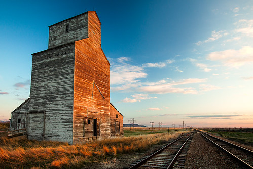 old railroad summer sky orange usa sunlight plant west building abandoned industry horizontal architecture clouds rural landscape outdoors evening countryside vanishingpoint wooden corn montana warm afternoon mt farm wheat united country rustic ruin harvest tracks bluesky nobody nopeople structure storage bin silo equipment business havre crop transportation stockphotos western tall states prairie copyspace agriculture peelingpaint laredo idyllic greatdepression grainelevator smalltown scenics obsolete granary stockphoto railroadtracks greatplains stockphotography hillcounty highway87 buildingexterior builtstructure economicdecline montanaphotography montanapictures