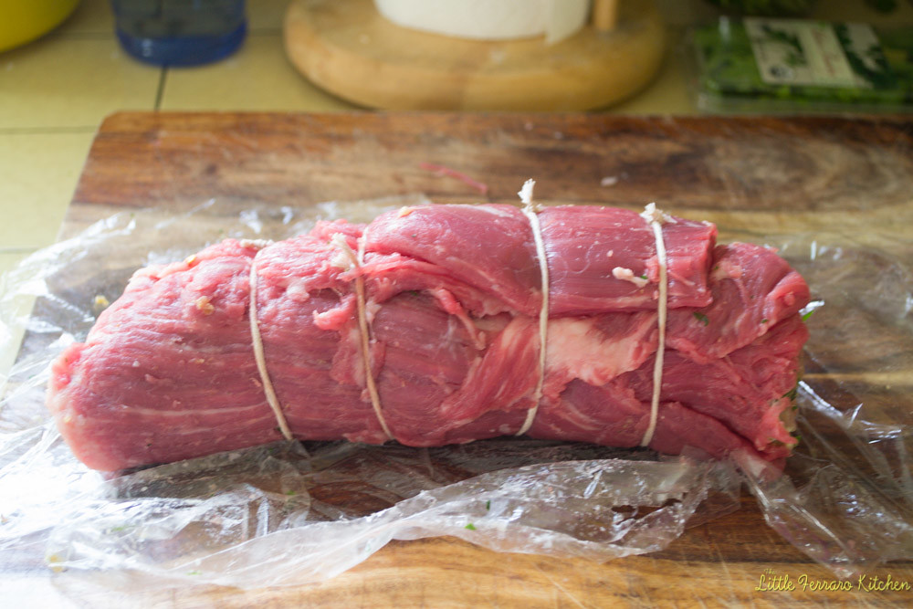 Roll the flank steak, making sure the braciole filling is tightly rolled up. Then use butcher string to tie the braciole.