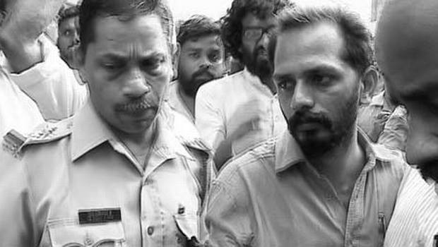 Thushar Sarathy being taken by the police. (Courtesy:  The Hindu)
