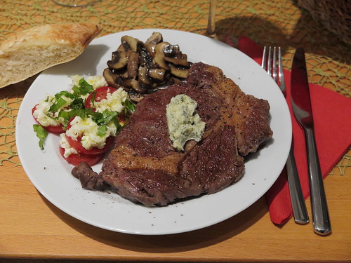 Galloway Rib Eye Steak mit Salbeibutter, geschmorten Champignons, Mozzarella-Tomaten und frisch gebackenem Weißbrot