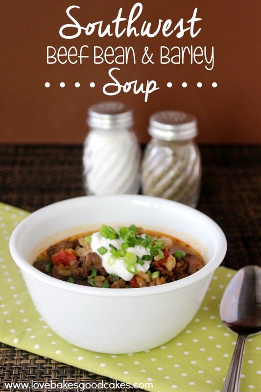 Southwest Beef Bean & Barley Soup in a white bowl with salt and pepper shakers and a spoon.