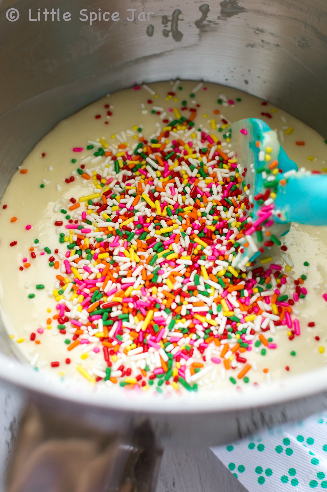 cupcake batter in mixing bowl with sprinkles on top