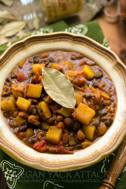 Slow Cooker Potato Curry Chili in a stoneware bowl with green linen and wood table top