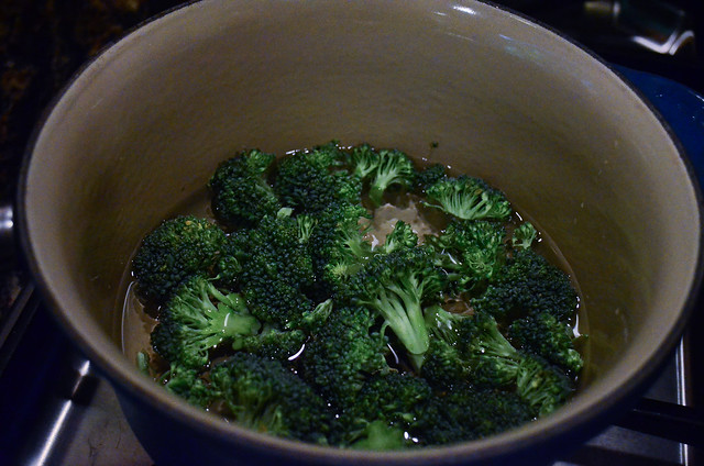 A pot with broccoli and water.