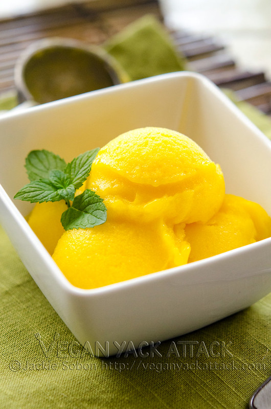 Mango Lime Sorbet in a white bowl with mint garnish