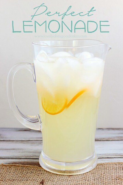 Perfect Lemonade in a glass pitcher with lemon slices and ice cubes. 